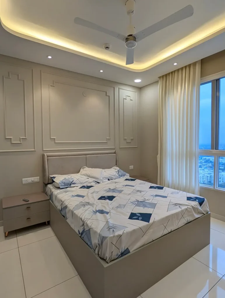 Completed bedroom in a Bengaluru 3 BHK with classic wall moulding, upholstered headboard, storage bed and cove-lit ceiling by Aladi Interiors