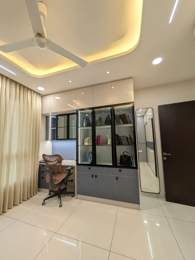 Completed study room in a Bengaluru 3 BHK with black-framed glass display unit, study desk, lofts and profile lighting by Aladi Interiors