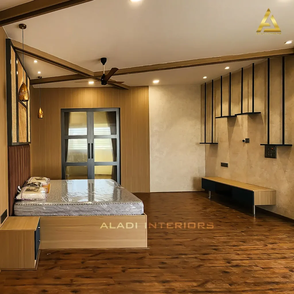 Completed master bedroom in a Gulbarga villa with wooden wall panelling, upholstered headboard, pendant lights and floating TV unit by Aladi Interiors